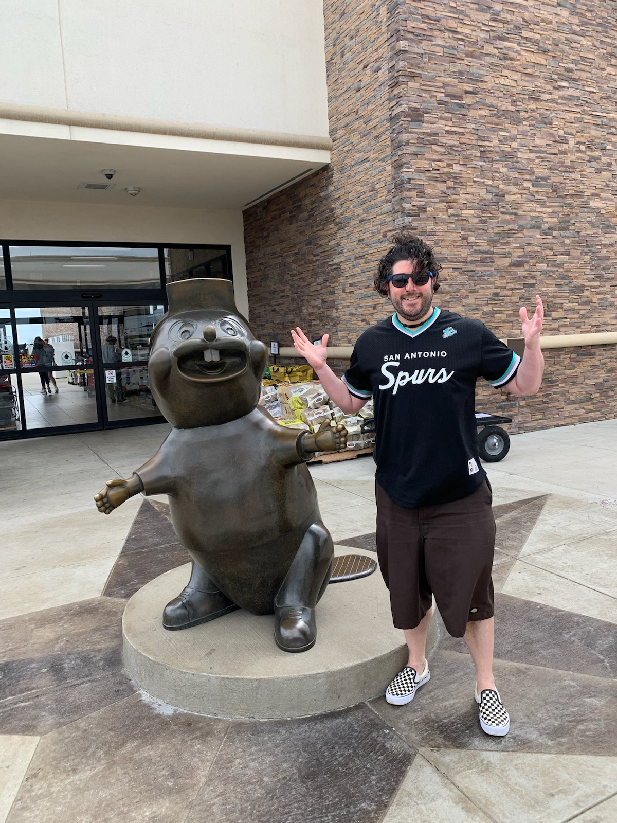 Lee shrugs at/with Buc-ee's in Texas (Pre-Covid).